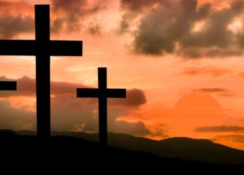 Three crosses on a hill at sunset, symbolizing Good Friday.