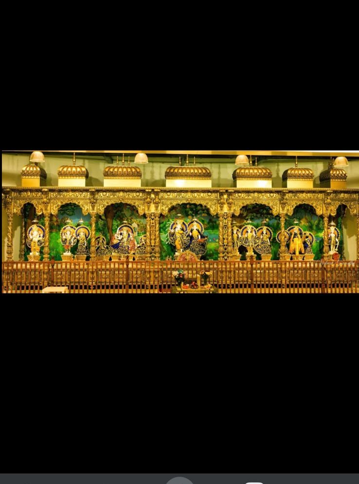 Deity idols displayed inside the sanctum of Leith Hindu Mandir in Edinburgh, adorned with traditional decorations and golden temple architecture.