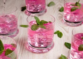 A glass of pink Pathimugam water, Kerala’s traditional Ayurvedic antioxidant drink.