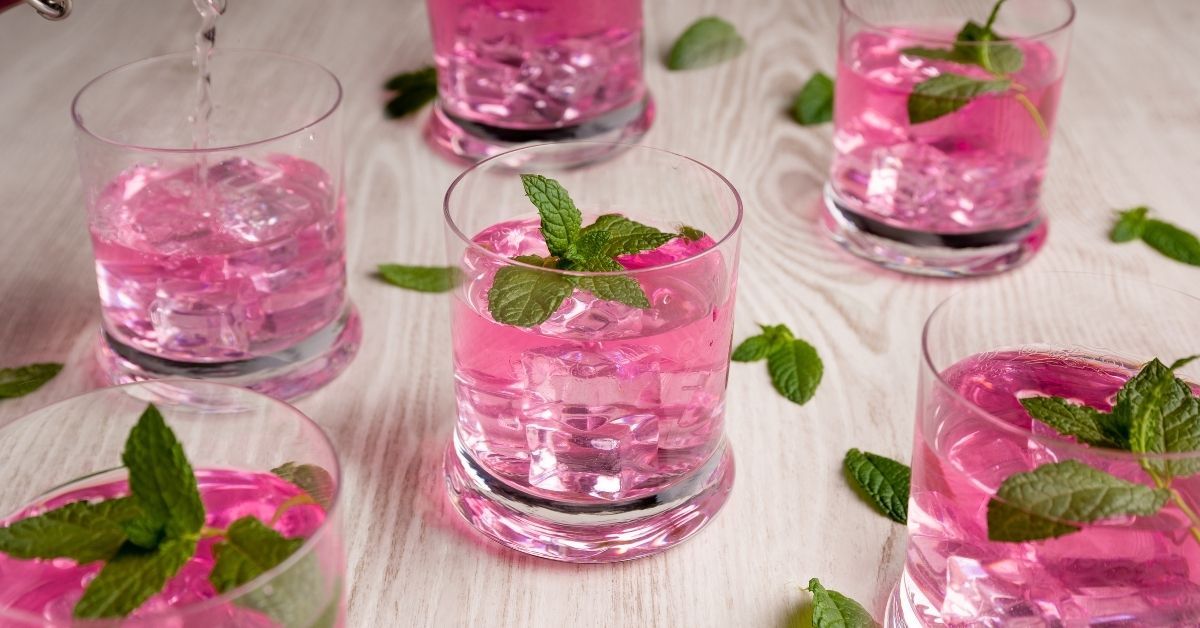 A glass of pink Pathimugam water, Kerala’s traditional Ayurvedic antioxidant drink.