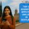 South Asian student in Edinburgh smiling while using a smartphone, with Scott Monument and Balmoral Hotel in the background. Text overlay: “Top 10 Essential Apps for Uni Life in Scotland” with ScottishIndian.com logo.