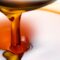 Golden sesame oil in a bowl with sesame seeds – Tila Tailam for hair, skin, and wellness